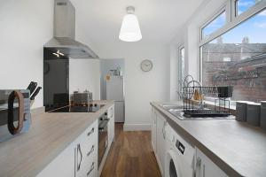 a kitchen with a stove top oven next to a window at Peaceful Dwelling at Falmer Road, Sleeps 4 in Darlington