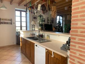 cocina con fregadero y encimera en Al Bioule - Maison climatisée avec piscine, en Penne-dʼAgenais