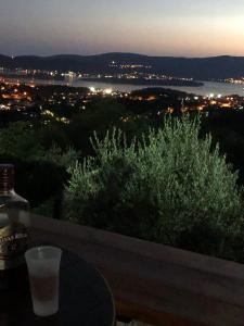 a drink sitting on a table with a view of the water at Sunset Holiday Home in Tivat +30 photos