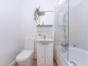 een badkamer met een toilet, een wastafel en een douche bij Elegant bright flat free parking Pass the Keys in Kingston upon Thames