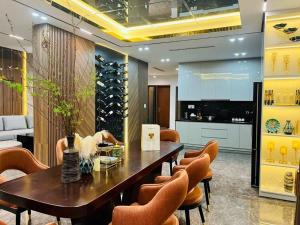 a dining room with a table and chairs and a wine cellar at Villa The Tropicana NVW Hồ Tràm in Ấp Thanh Bình