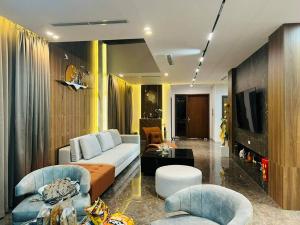 a living room with a couch and two chairs at Villa The Tropicana NVW Hồ Tràm in Ấp Thanh Bình