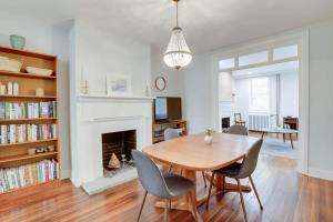 a dining room with a table and chairs and a fireplace at Sojourn Historic Location 2 BR 2 BA in Washington