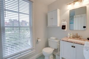 a bathroom with a toilet and a sink and a window at Sojourn Historic Location 2 BR 2 BA in Washington