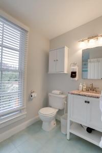 a white bathroom with a toilet and a sink at Sojourn Historic Location 2 BR 2 BA in Washington