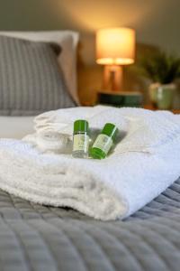two bottles of soap and towels on a bed at The Downe Arms Hotel in Castleton