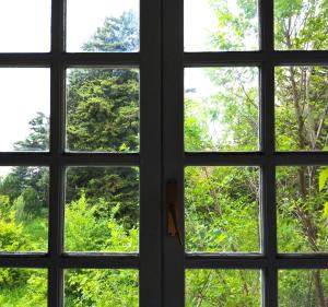 a view through a window looking out at trees at Quiet light room! in Zizur Mayor