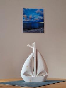 a white sculpture of a white boat on a table at Achtern Diek 15a Whg 1 - a86744 in Zingst