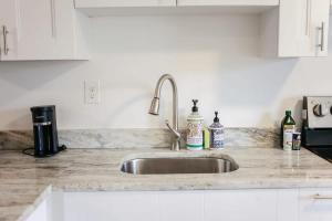 a kitchen counter with a sink in a kitchen at Sojourn Beachside Hideaway 2 BR in Norfolk