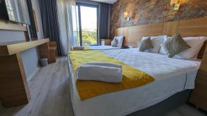 a bedroom with a large bed with a yellow blanket at Antalya Ramona in Antalya