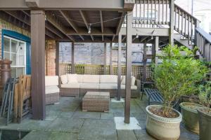 a patio with a white couch on a porch at Sojourn 1 BR with private patio in Washington, D.C.