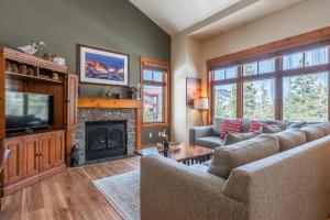 a living room with a couch and a fireplace at Cabins 24 in Mammoth Lakes