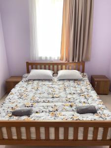 a bed with two pillows on it in a bedroom at LaoVardi Hotel in Gori +3 photos