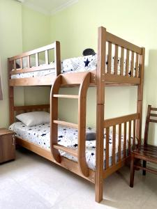 two bunk beds in a room with a chair at LaoVardi Hostel in Gori