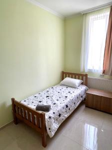 a bedroom with a bed and a window at LaoVardi Hotel in Gori