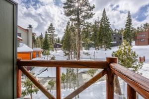 a view from the balcony of a cabin in the snow at Cabins 24 in Mammoth Lakes