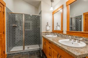 a bathroom with two sinks and a shower at Cabins 24 in Mammoth Lakes +25 photos