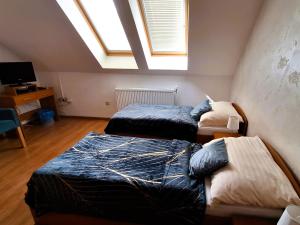 A bed or beds in a room at Penzión Villa Agnes
