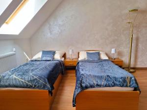 A bed or beds in a room at Penzión Villa Agnes