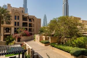a view of a city with a bench and buildings at Frank Porter - Reehan 5 in Dubai