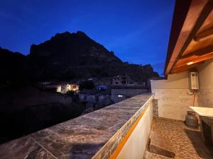 a balcony with a view of a mountain at night at Casa SAMAY OLLANTAYTAMBO in Ollantaytambo
