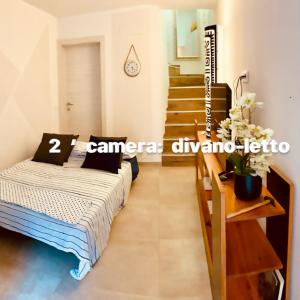 a bedroom with a bed and a staircase in a room at CasaBella Chioggia casa indipendente con corte in Chioggia