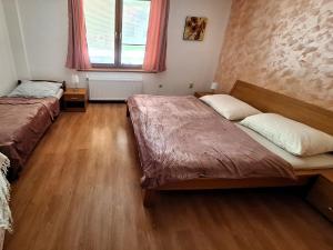 A bed or beds in a room at Penzión Villa Agnes