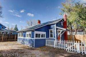 a blue house with a white fence at *H* NEW! Downtown Cottage Newly Renovated! * in Colorado Springs