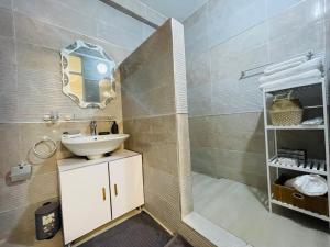 a bathroom with a sink and a mirror at ESPACE VIRAGE 2 in Dakar