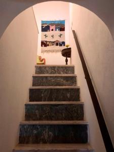 a stairway with a painting on the wall at Casa David in Castelo de Vide