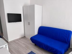 a blue couch in a room with a tv at White and Blue Bodrum in Bodrum City