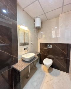 a bathroom with a sink and a toilet at Hotel Sky Wood At Airport in New Delhi