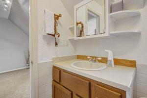 a bathroom with a sink and a mirror at Charming Victorian Haven Near Garden of the Gods in Colorado Springs