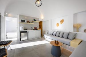 a living room with a couch and a table at Hypnōs boutique villa with amazing heated pool with jacuzzi in Fira