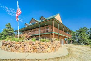 a large house with a flag in front of it at Nature's Oasis 4BD Ranch Retreat Hot tub in Peyton +108 photos