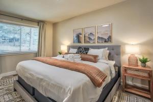 a bedroom with a large bed and a window at 4BD With Game Lounge Hot tub Dog Friendly USAFA in Pikeview +46 photos