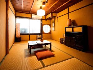 京都的住宿－和樂安旅館，客厅配有咖啡桌和电视