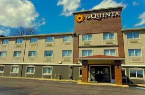 a hotel with a sun sign on the front of it at La Quinta Inn by Wyndham Indianapolis North at Pyramids in Indianapolis