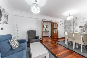 a living room with a blue couch and chairs at Portu Style by Aston Rentals in Portugalete