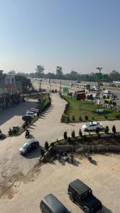 a group of cars parked in a parking lot at Shivjot hotel in Kharar