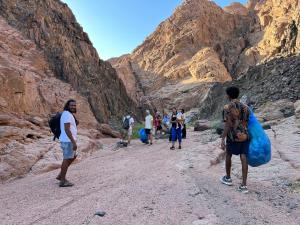 a group of people walking through a canyon at My Hostel in Dahab - Dive center in Dahab