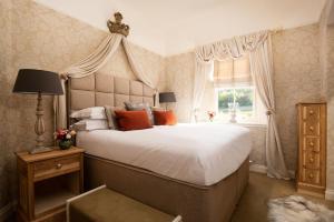 a bedroom with a large bed and a window at The Bothy at Dryburgh in Saint Boswells