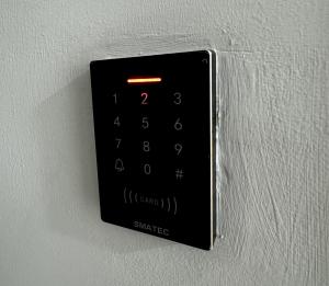 a remote control hanging on a wall at Cozy Apartment in Boshar in Muscat