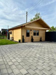 a small house with a brick driveway in front of it at Chalet Lasserg in Münstermaifeld
