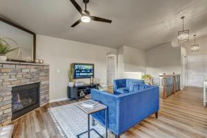 a living room with a blue couch and a fireplace at Room to Spread Out & Deck with Mountain Views in Monument