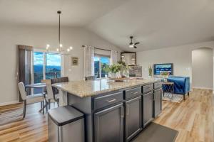 a kitchen and dining room with a large counter top at Room to Spread Out & Deck with Mountain Views in Monument