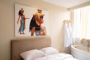 a bathroom with a painting of a woman on the wall at King of Pharaohs INN pyramids in Cairo