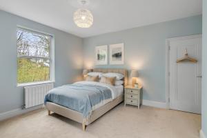 a bedroom with a bed and a window at Stunning coastal 6/bed house w/parking & garden in Cromer