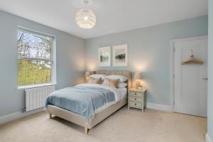 a bedroom with a bed and a window at Coastal 6-bed with hot tub in Cromer