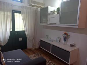 a living room with a table and a green door at La Maisonette in Sori
